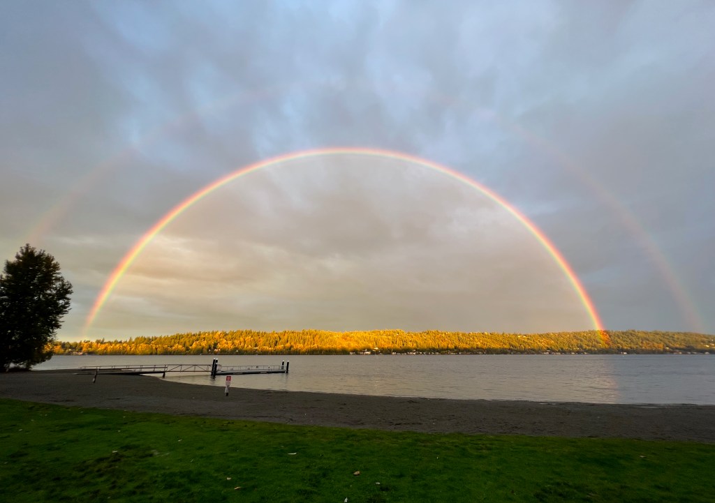 Double rainbow at sunset over a lake