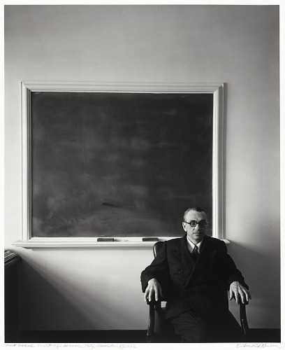 Portrait of Kurt Gödel sitting in front of a blackboard, taken at Princeton by the photographer Arnold Newman