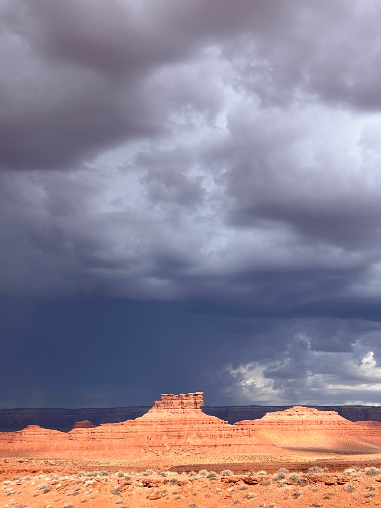 Dark clouds over a butte in Valley of the Gods, Utah. 